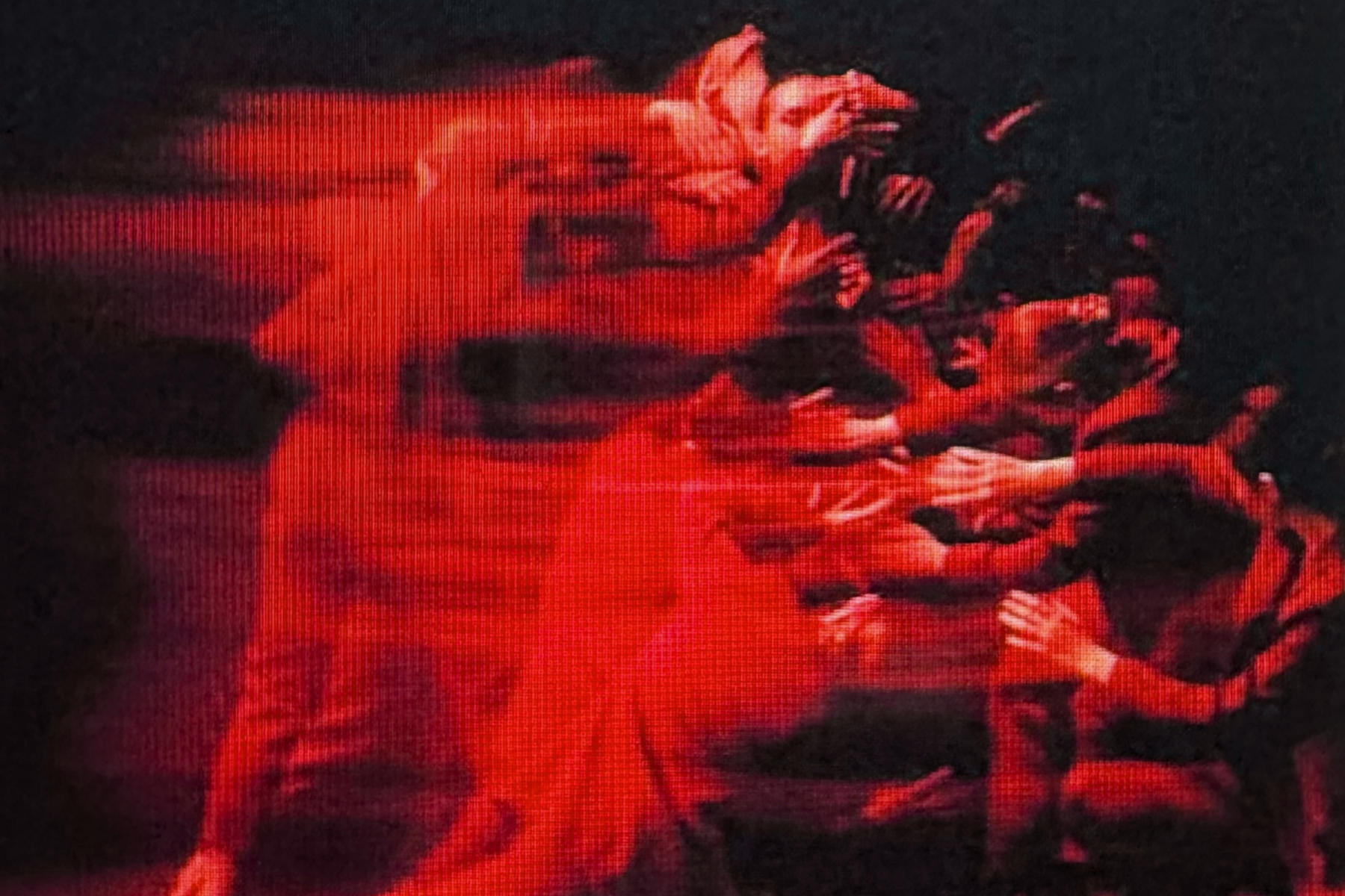 Group of dancers with red lighting and motion blur