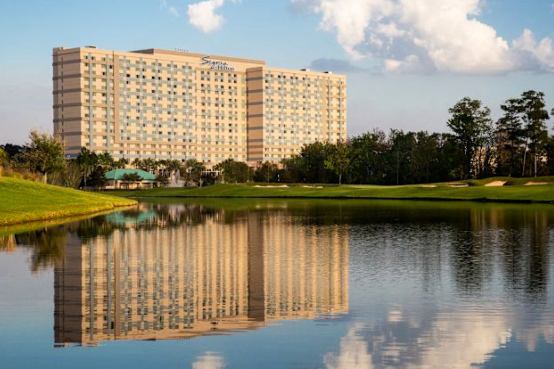 Orlando Hilton hotel with trees and water in front