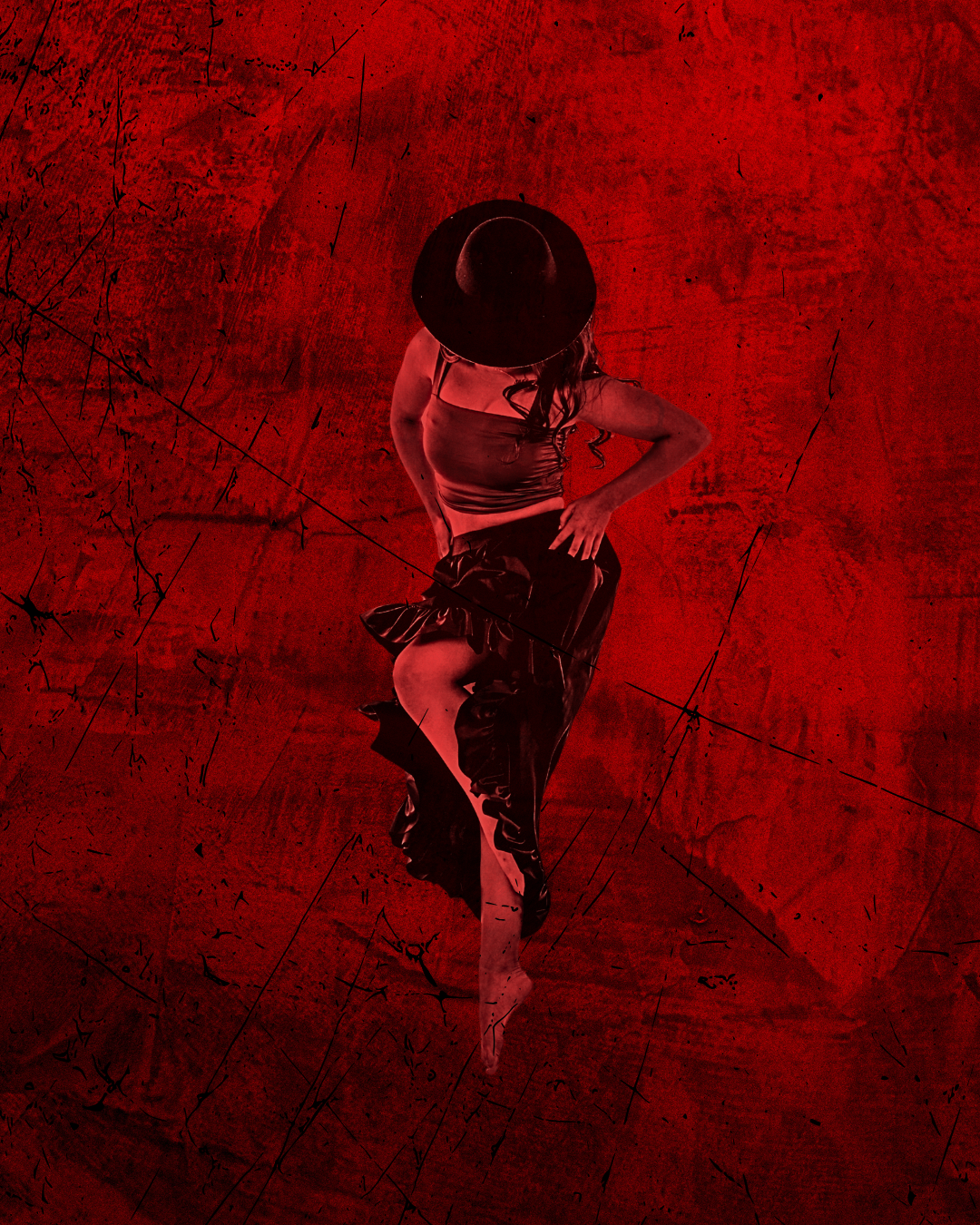Female dancer posed looking down wearing black hat with red lighting and red background